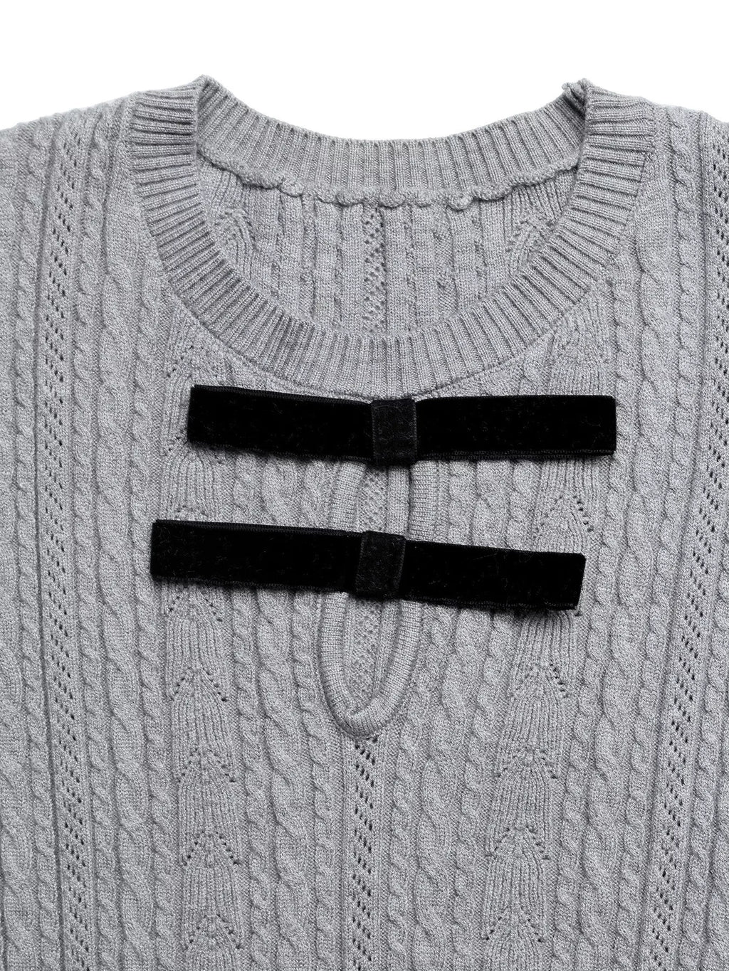 Gray cable knit sweater with black ribbed trim on a white background