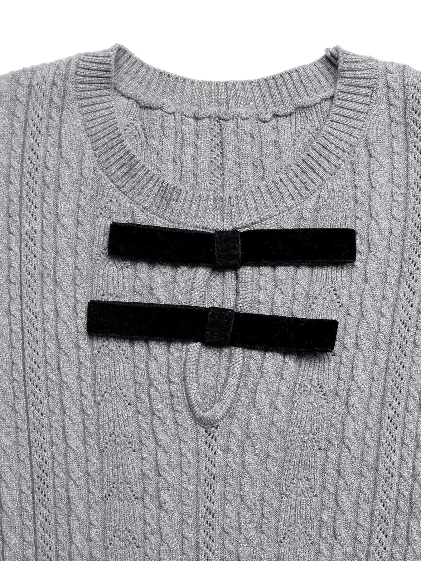 Gray cable knit sweater with black ribbed trim on a white background