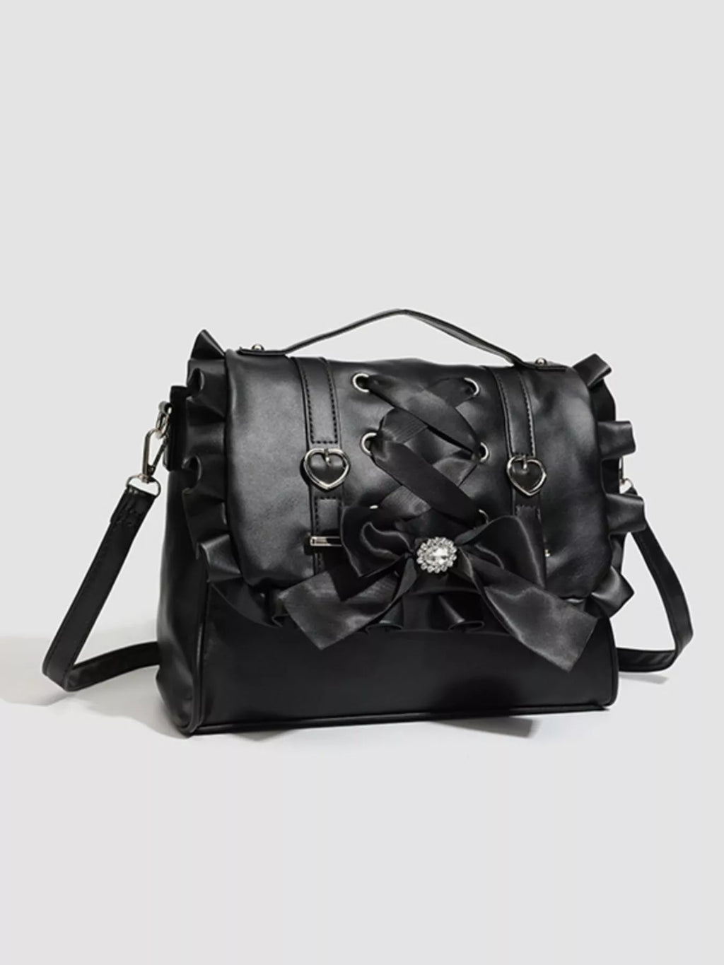 Black handbag with decorative bows on a light gray background