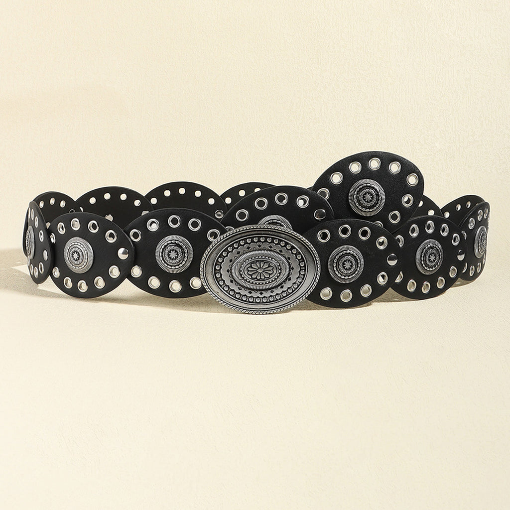 Black belt with silver circular patterns on a beige background