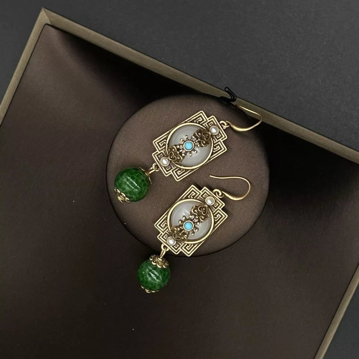 Image 3: Goddess Copper Dark Green Resin Dangle Earrings – angle view

